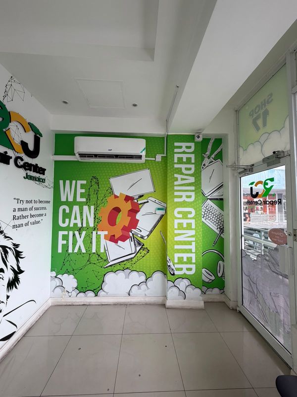 A wall mural inside the shop that reads We can fix it